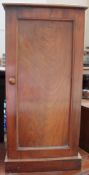 A Victorian mahogany pot cupboard with a square top above a single door on a plinth