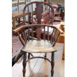 A 19th century child's yew Windsor chair with a vase and spindle back above a solid seat and