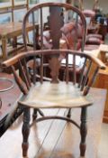 A 19th century child's yew Windsor chair with a vase and spindle back above a solid seat and