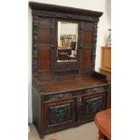 A 19th century oak low countries mirror back sideboard, carved with flowerheads and leaves,