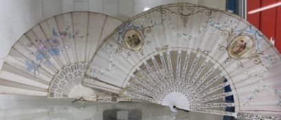 A silk fan with pierced bone guard sticks,