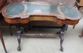 A Victorian burr walnut ladies writing table with a recessed pen tray and raised inkwell,