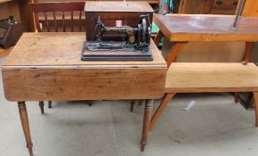 A Victorian mahogany Pembroke table together with a Singer sewing machine, two coffee tables,