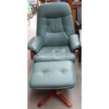 A green leather reclining chair and stool