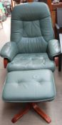 A green leather reclining chair and stool