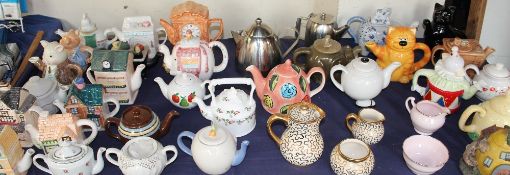 A collection of novelty tea pots