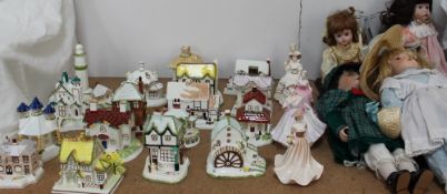 A collection of Coalport cottages together with Coalport ladies and collectors dolls