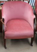 An Edwardian mahogany tub chair on square tapering legs and casters