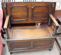 A 20th century oak monks bench, with a tilting top,