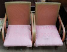 A pair of wicker pink and gilt decorated arm chairs