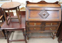 A 20th century oak bureau together with two oak side tables