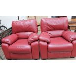 A pair of red leather upholstered chairs