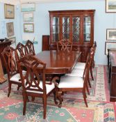 A reproduction mahogany dining suite including an extending dining table,