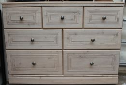 A modern chest with seven assorted drawers