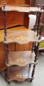 A Victorian inlaid walnut four tier whatnot with shaped shelves and turned uprights