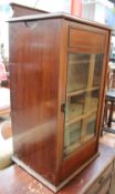 A mahogany pot cupboard with a glazed door and shelves