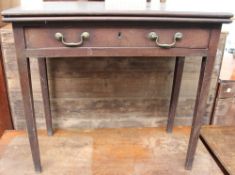 A George III mahogany tea table with a rectangular moulded fold over top above a single drawer on