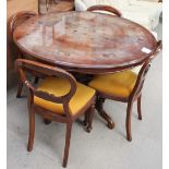 A reproduction mahogany inlaid dining table and four chairs with a sideboard