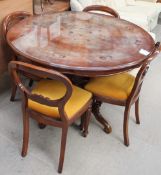 A reproduction mahogany inlaid dining table and four chairs with a sideboard