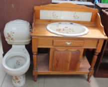 A late 1980s bathroom set including a toilet and cistern with a matching wash basin mounted in a