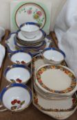 A Clarice Cliff sandwich plate together with a part tea service and sandwich set