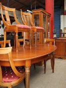 A modern satin walnut extending dining table together with six chairs,