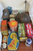 A tin helmet together with assorted tins etc