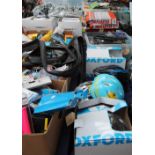 A large collection of bicycle accessories, bicycle helmets, racks,