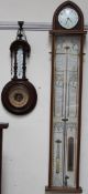 An Admiral Fitzroy barometer with a clock to the apex, by Comitti of London, with a mercury tube,
