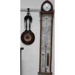 An Admiral Fitzroy barometer with a clock to the apex, by Comitti of London, with a mercury tube,