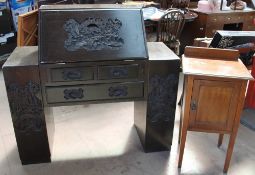 A Chinese carved hardwood bureau with a sloping fall and two pedestals with an arrangement of