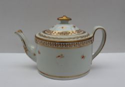 A 19th century porcelain teapot of oval form decorated with a floral band in gilt lines,