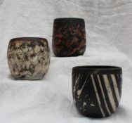 Studio pottery by Barbara Ineson - A pottery cylindrical vase decorated in black stripes,