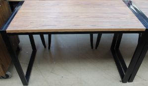 A set of four walnut and black metal cafe tables