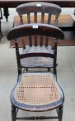 A pair of oak ladder back dining chairs