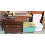 A Singer sewing machine together with a modern chest of drawers, loom laundry basket,