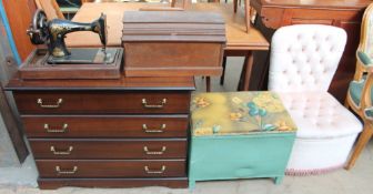 A Singer sewing machine together with a modern chest of drawers, loom laundry basket,