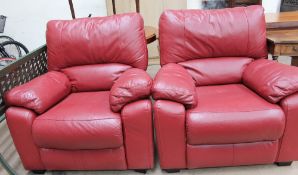 A pair of red leather upholstered chairs