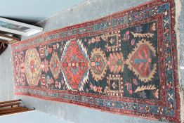 A red ground runner and a small rug