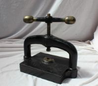 A Victorian cast iron book press with bronze ball handles,