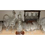 A Tantalus with crystal decanters, together with glass canters, drinking glasses, ship in a bottle,