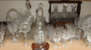 A Tantalus with crystal decanters, together with glass canters, drinking glasses, ship in a bottle,