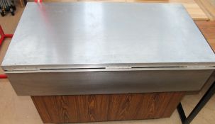 A stainless steel topped serving station on wheels