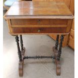 A Victorian walnut work table with a rectangular top above two drawers and turned legs