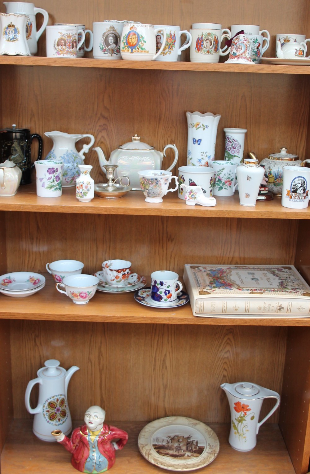 A collection of commemorative mugs together with assorted decorative ceramics including vases,