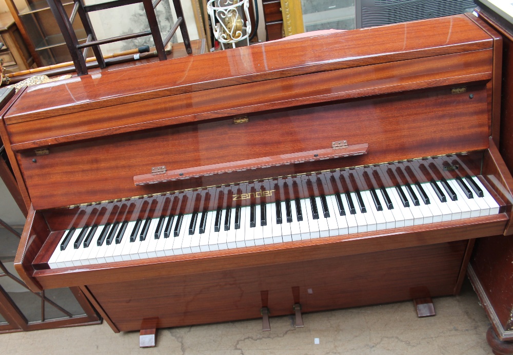 A Zender mahogany upright piano