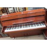 A Zender mahogany upright piano