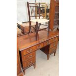 An Edwardian mahogany dressing table with an arrangement of six drawers on tapering legs together