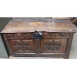 An 18th century coffer with carved front and sides on stiles