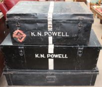 A black painted tin trunk together with two other tin trunks